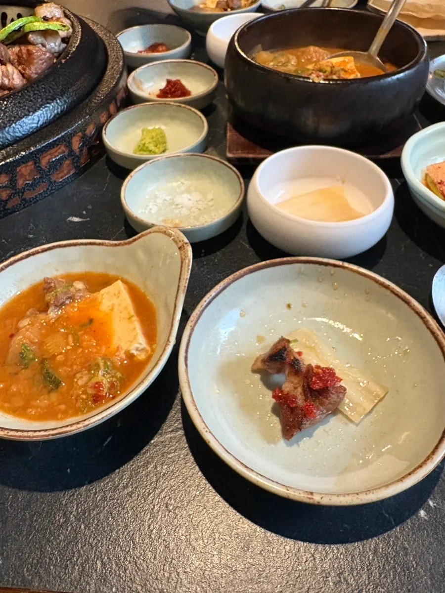 A bowl of doenjang jjigae served alongside the meat