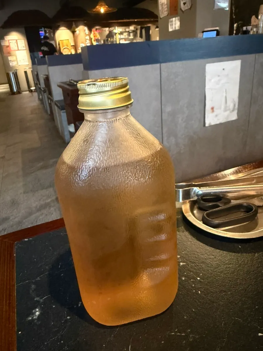 Barley tea served in a Del Monte glass bottle