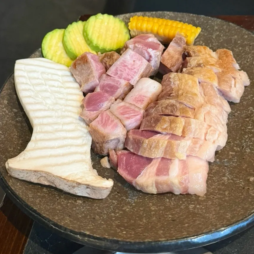 Spread of aged pork belly, pork neck, and vegetables for grilling