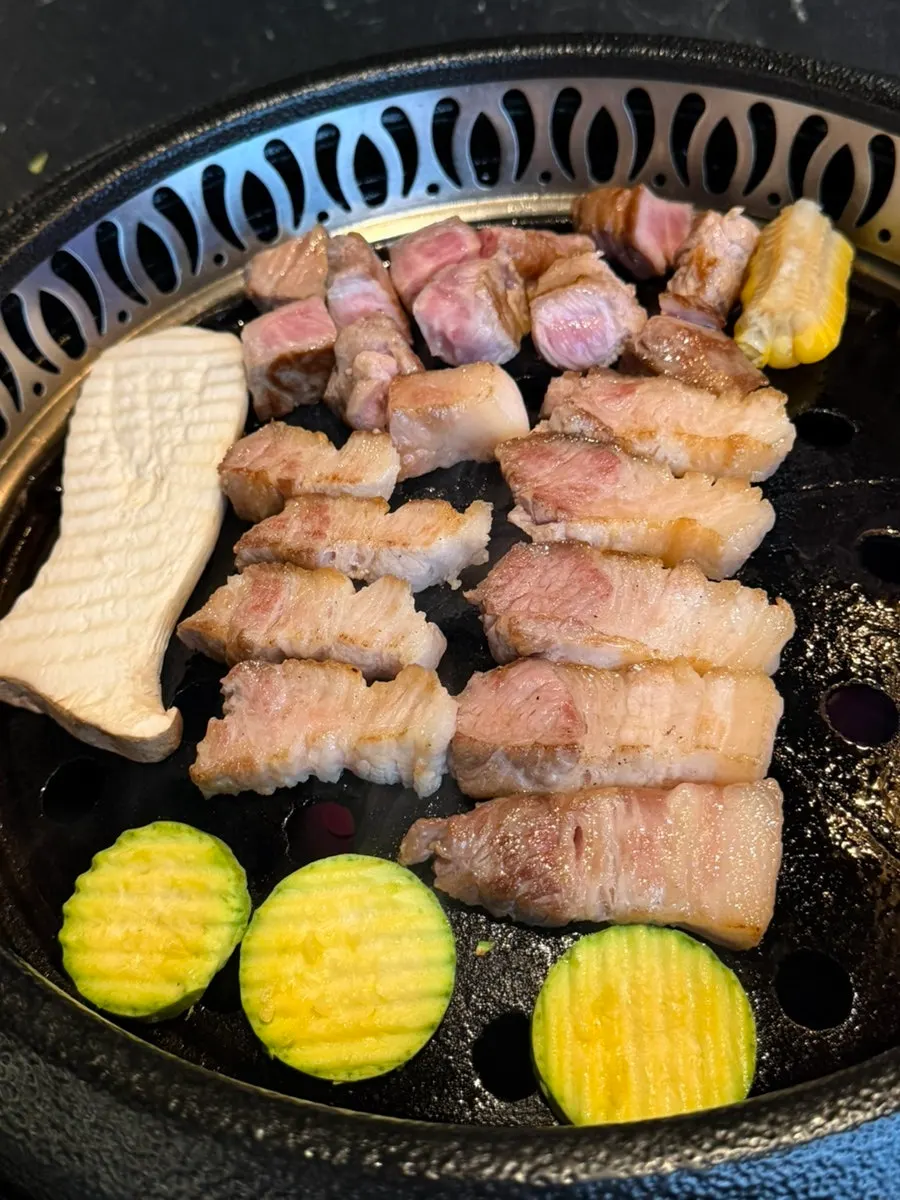 Grill being prepared with brushed-on meat fat