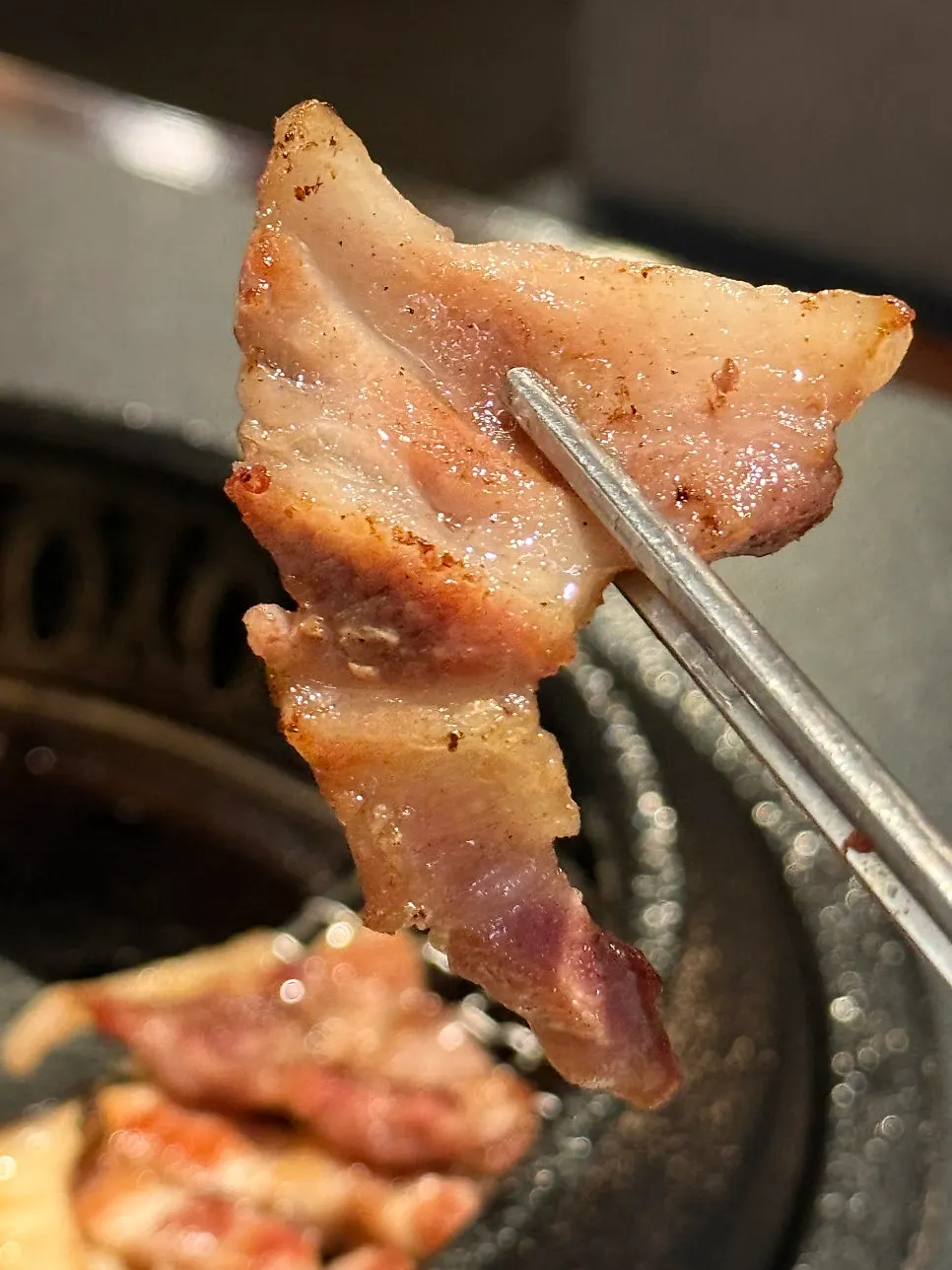 A piece of samgyeopsal dipped in Maldon salt