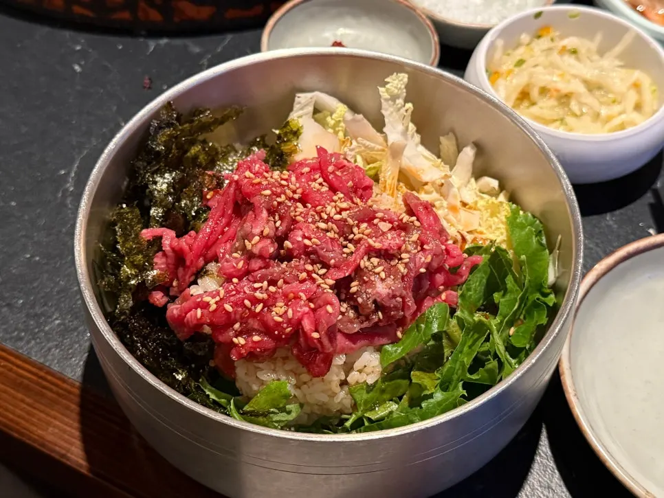 Yukhoe bibimbap generously topped with raw beef