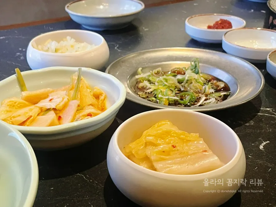 Table set with banchan and meat sauces