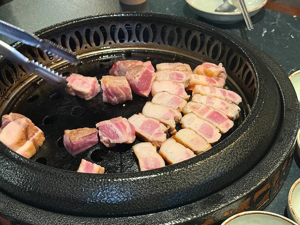 직원이 불판에서 고기 굽는 모습