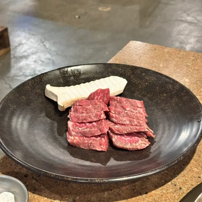 Raw platter of Sansol aged pork belly, aged skirt meat, and jin flower short rib