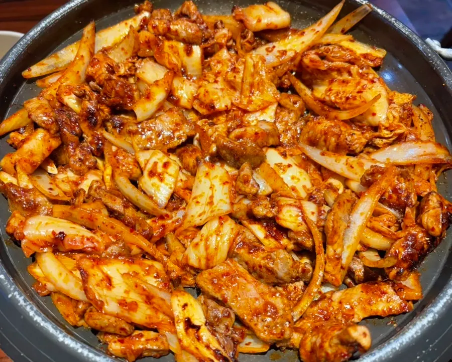 The medium size pork kimchi grill on the grill at Sarangjip