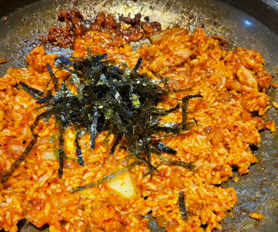 Finishing fried rice being cooked on the grill