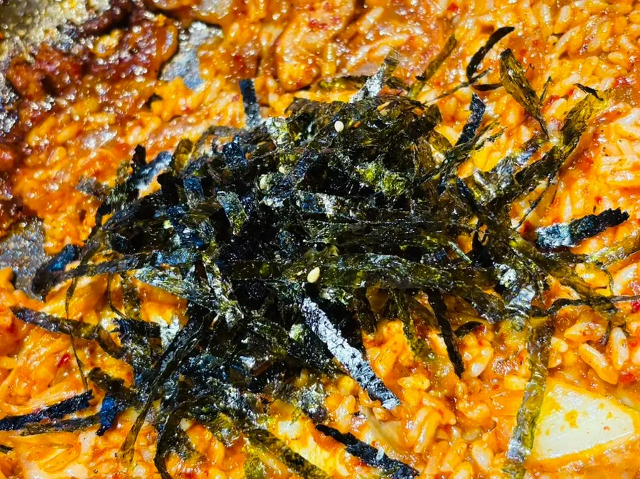 Sarangjip's finishing fried rice topped with seaweed flakes