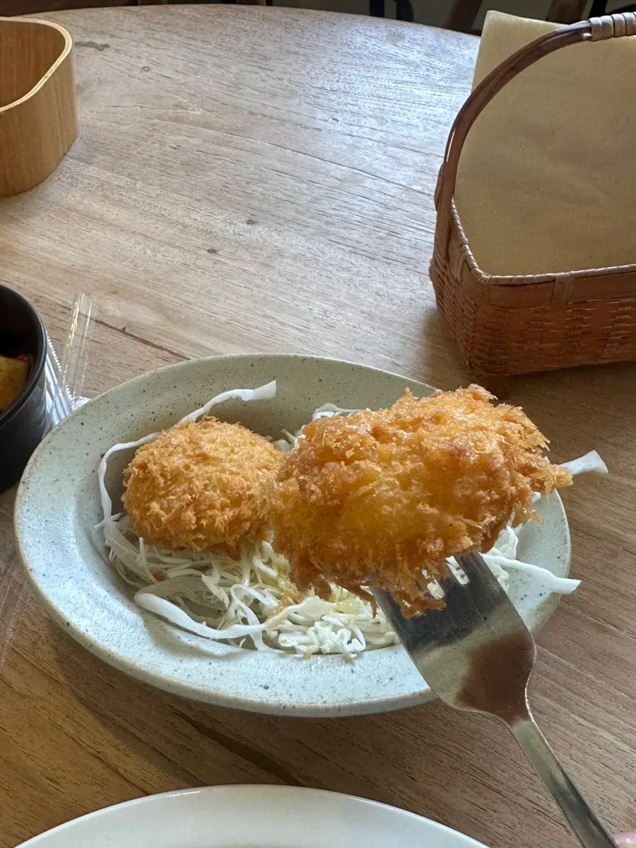 Sweet potato cheese croquette on a bed of cabbage salad