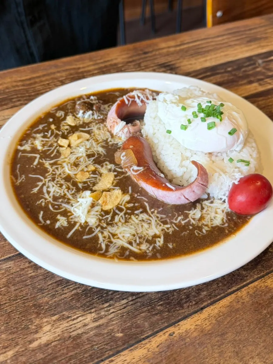 Special curry topped with poached egg and sausage