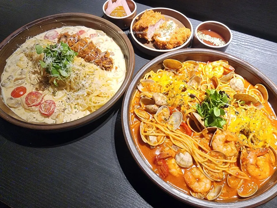 Sasaenghwal spread with two plates of pasta and a side dish