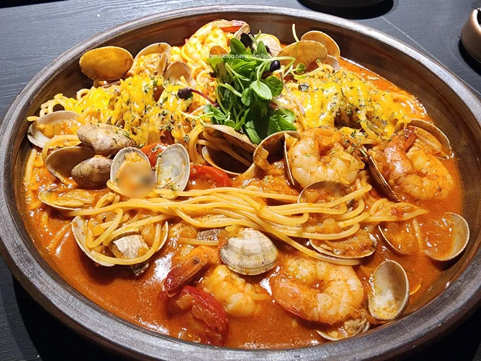 Seafood tomato pasta topped with clams and shrimp