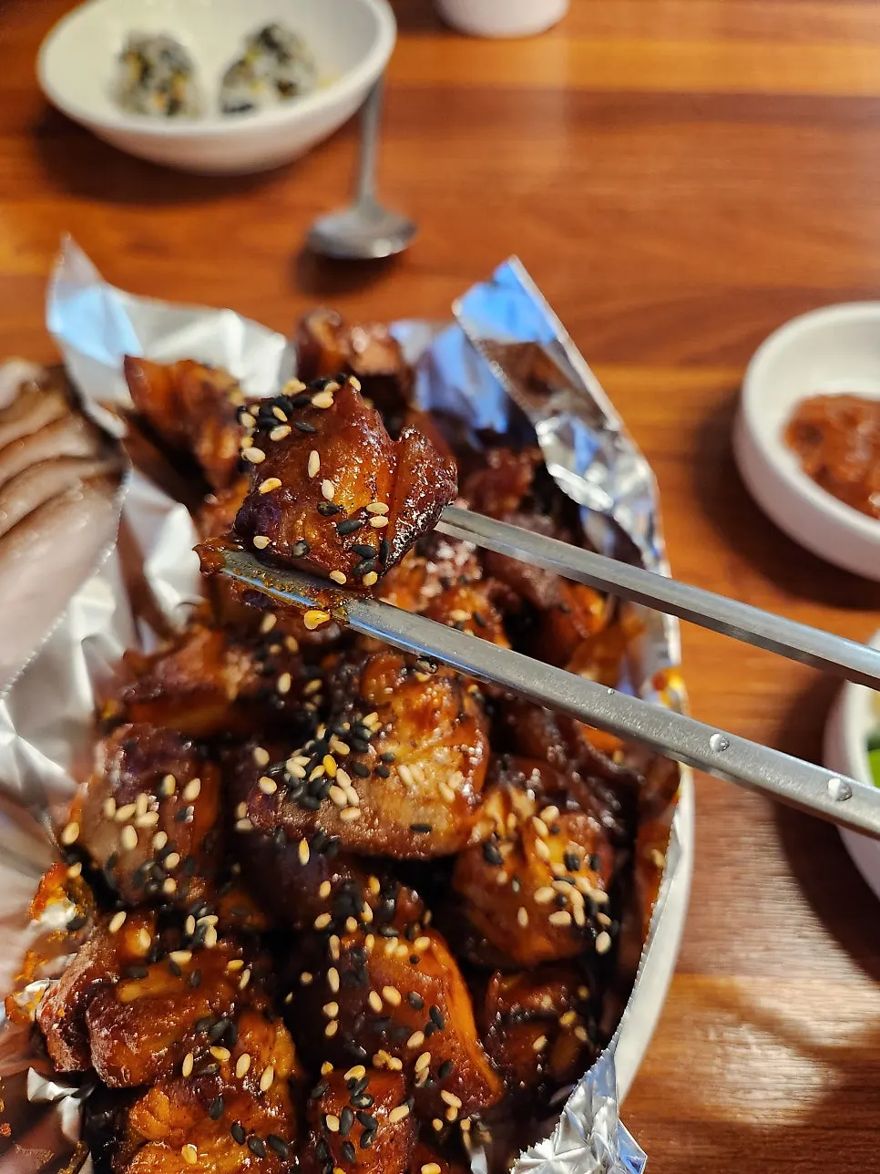 Chopsticks picking up spicy jokbal
