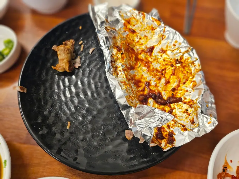 Holding up a piece of spicy jokbal