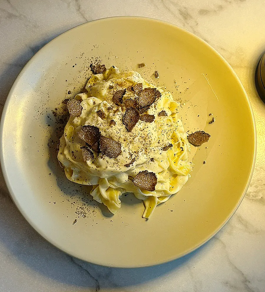 Truffle tagliatelle finished by mixing in the cheese wheel