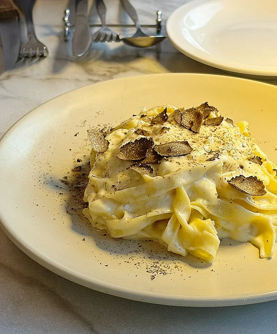 Fresh tagliatelle noodles twirled on a fork
