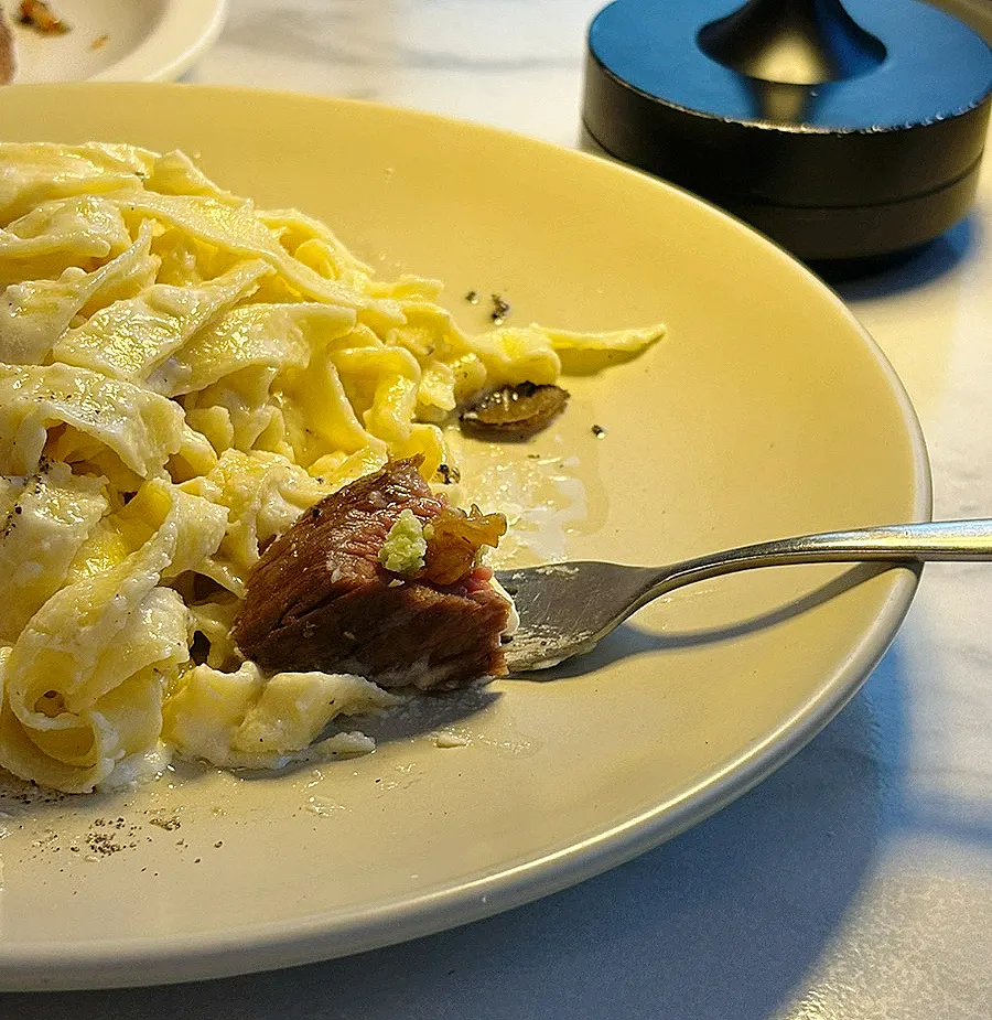 A plate combining both pasta and steak