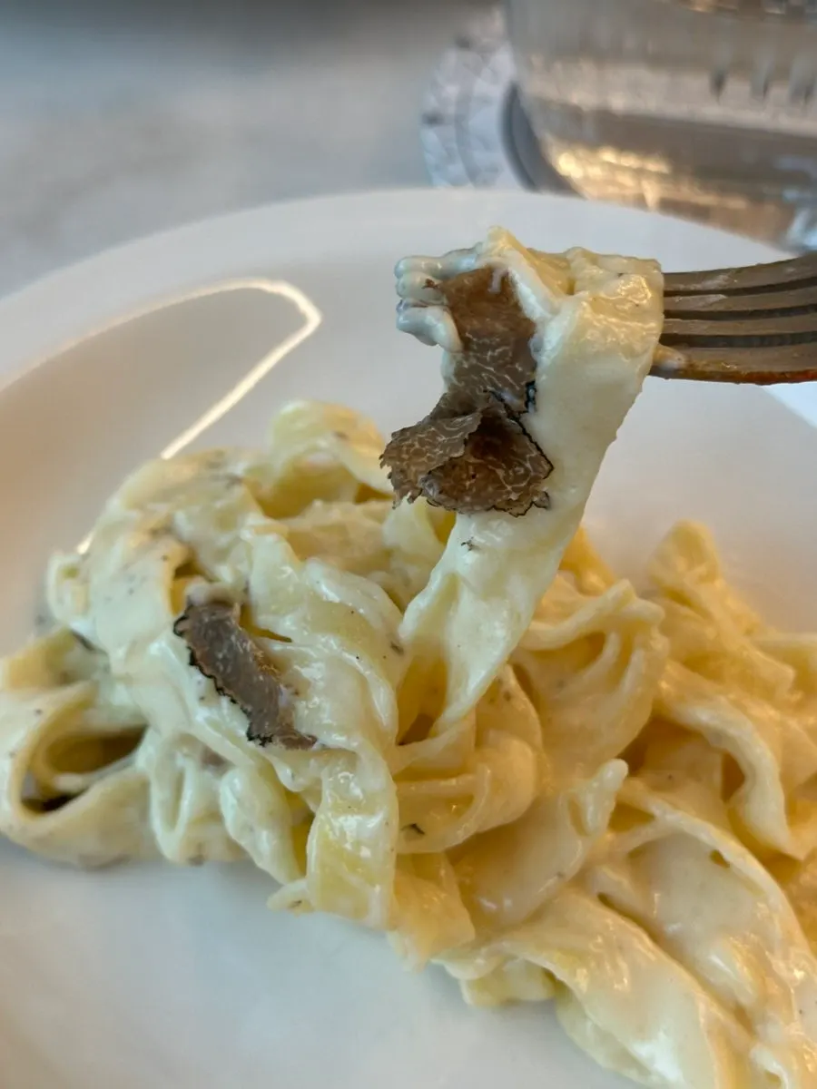 The finished truffle cheese wheel tagliatelle