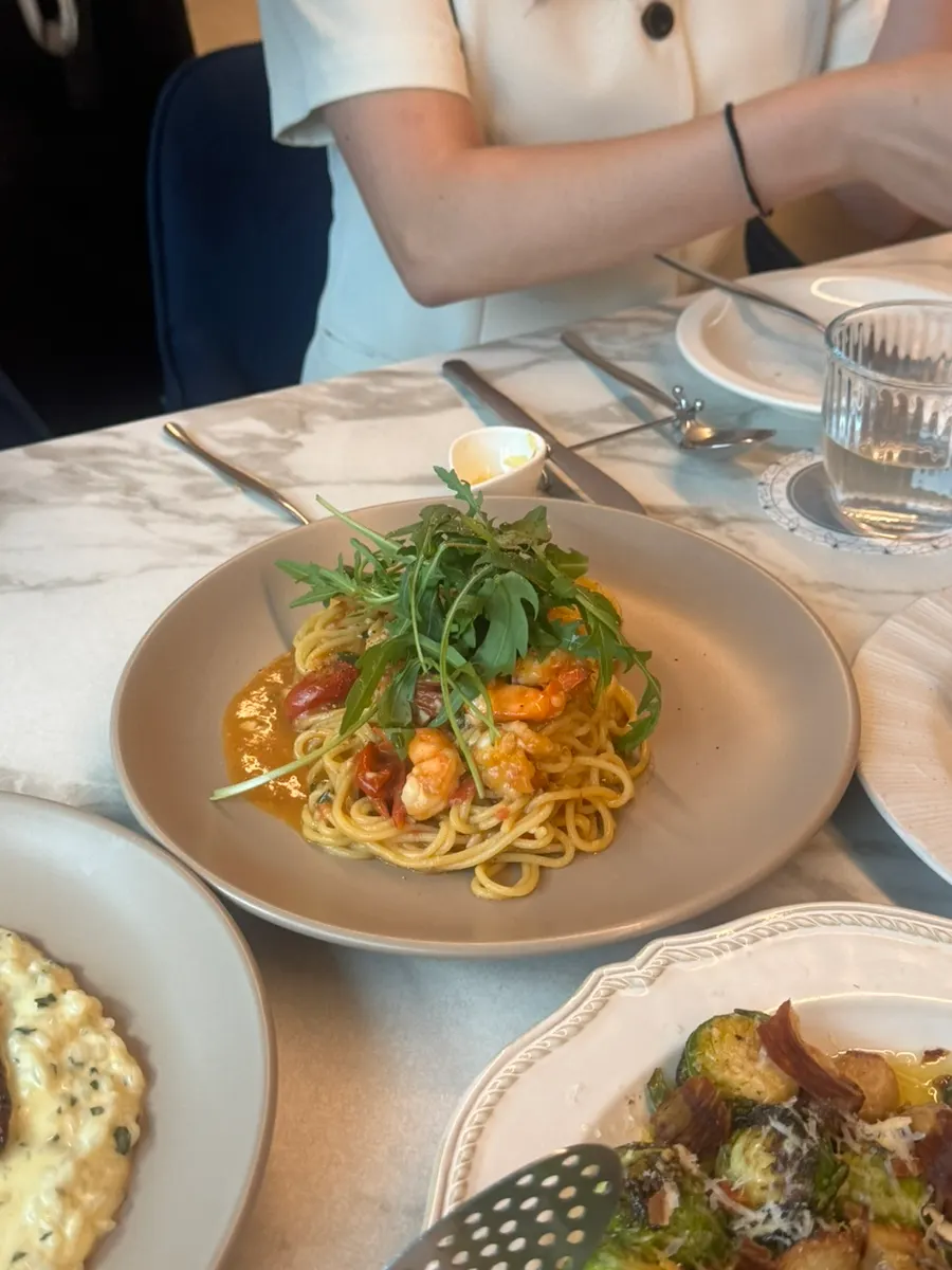 Prawn oil pasta topped with shrimp and cherry tomatoes