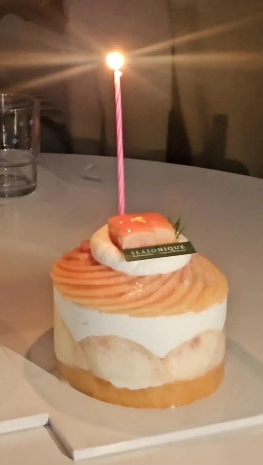A single candle lit on Siznique's Floral Peach