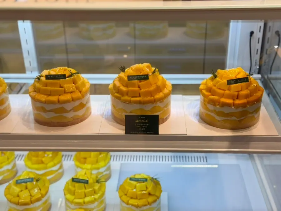 Price signage for mango, peach, and fig cakes