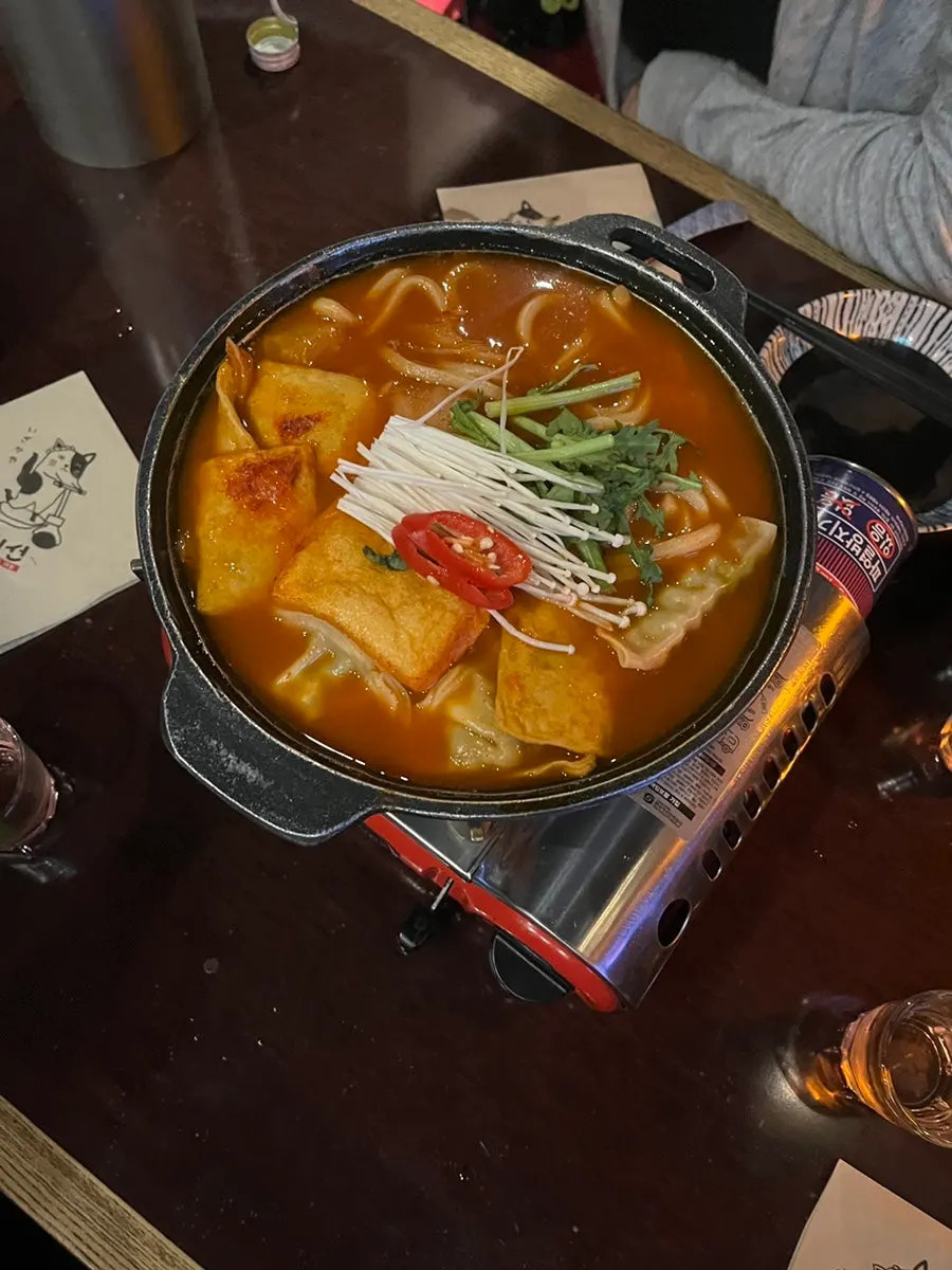 Pot of fried tofu kimchi udon simmering away