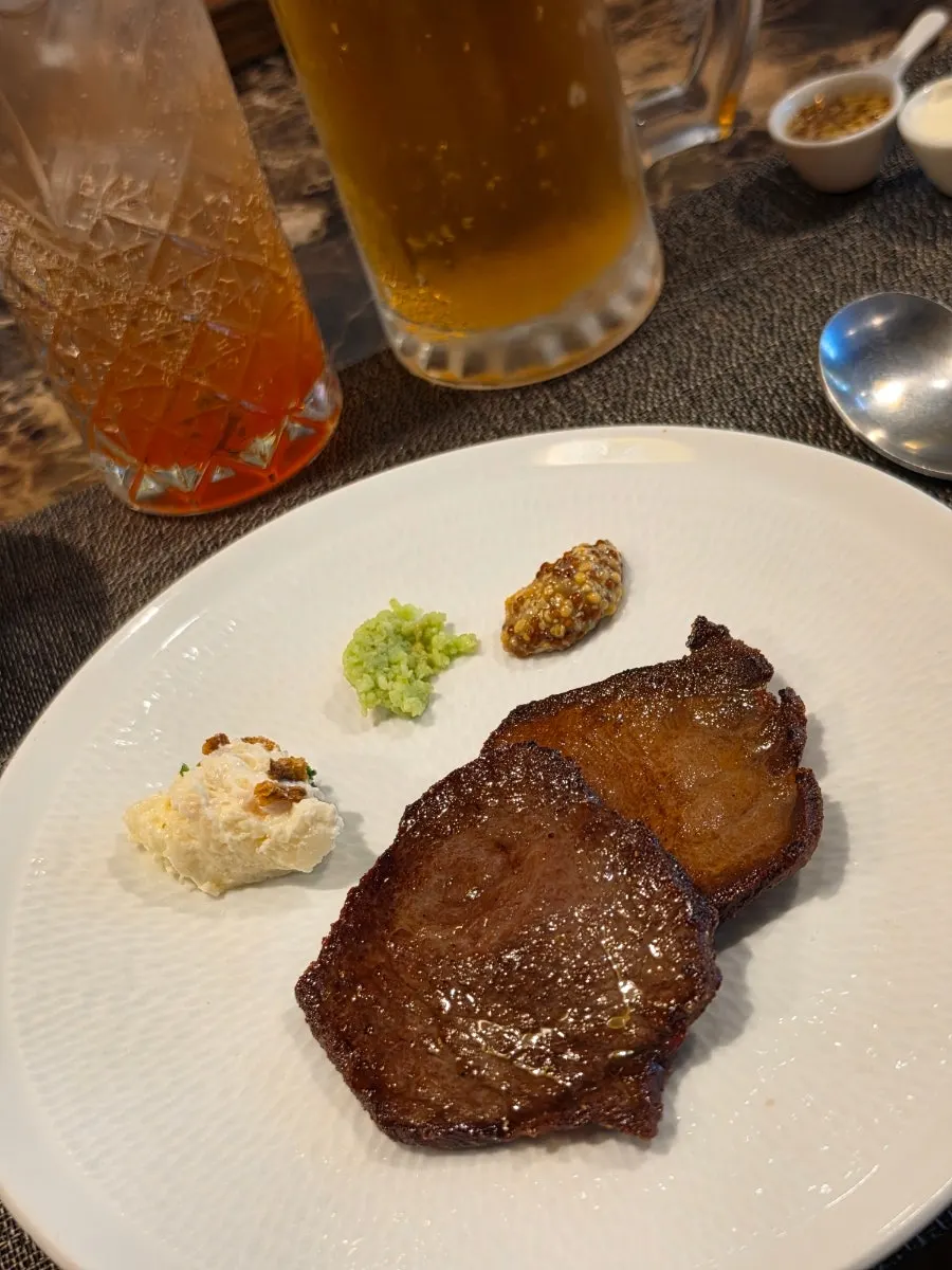 Close-up of beef tongue steak served with wasabi