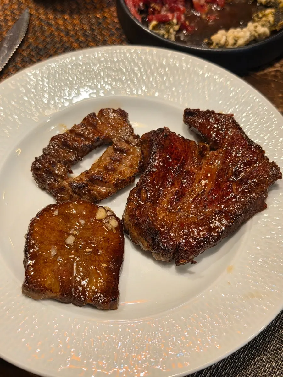 Three plates: garlic salt beef tongue, galbisal, and sirloin steak