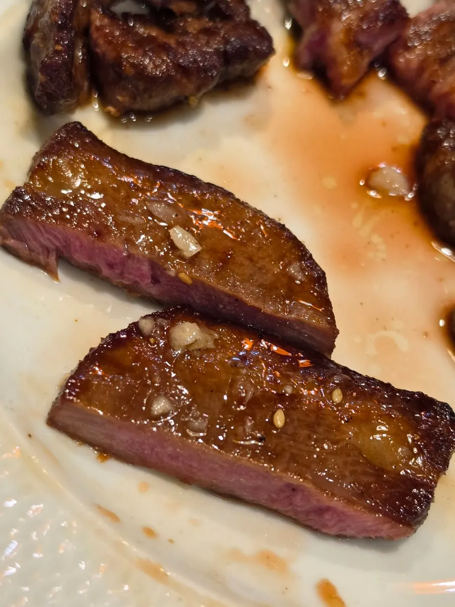Garlic salt beef tongue steak topped with garlic sauce