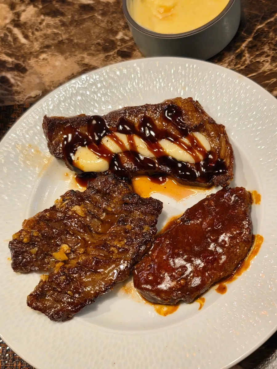 Three seasoned steaks: soy sauce, garlic mayo, and demi-glace