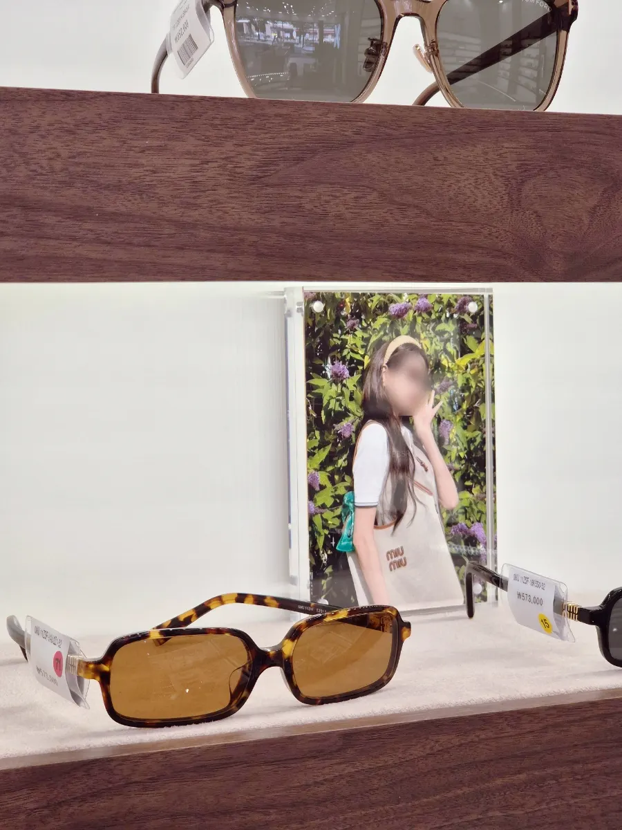 Display of house brands including MOSCOT