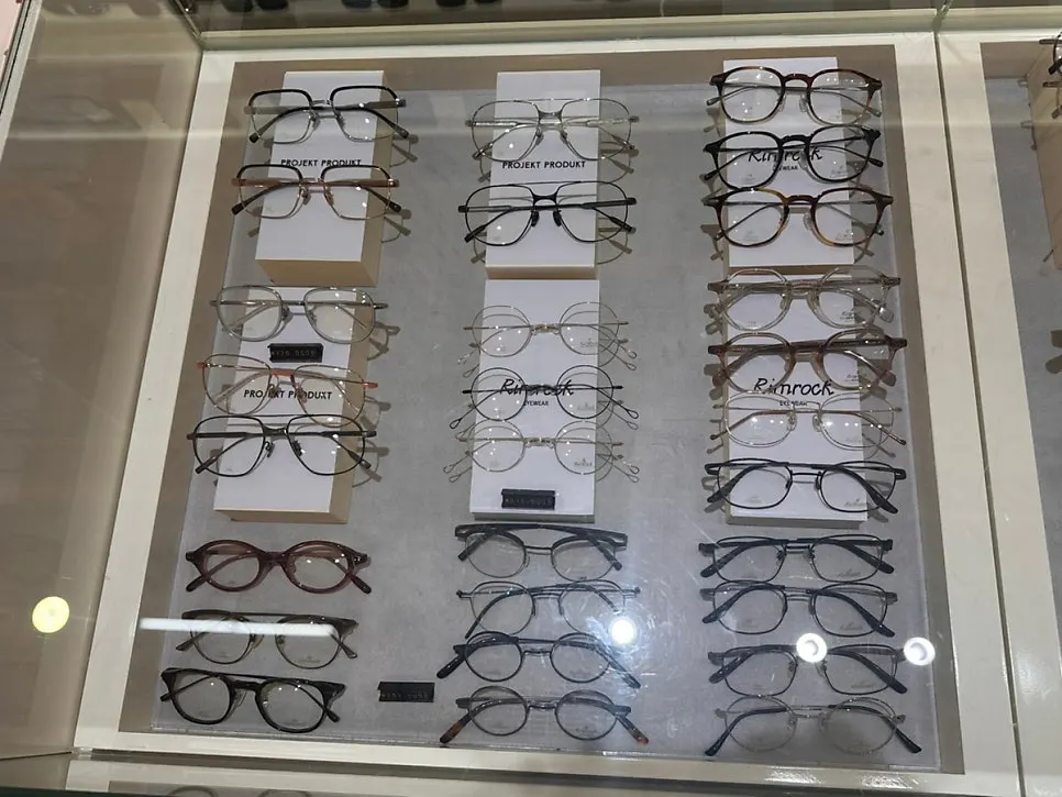 Eyewear frames organized by brand in a showcase