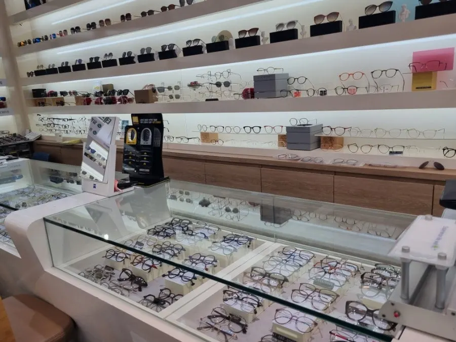 Sunglasses organized by brand toward the back of the store