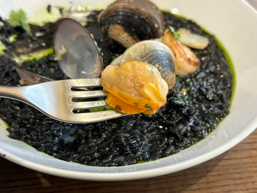 Close-up of Sedici's thick, creamy squid ink risotto