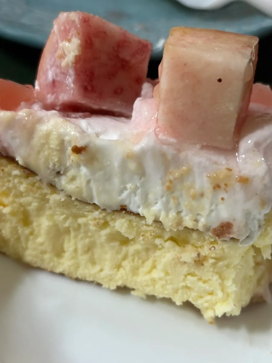 A forkful of the peach cake being lifted