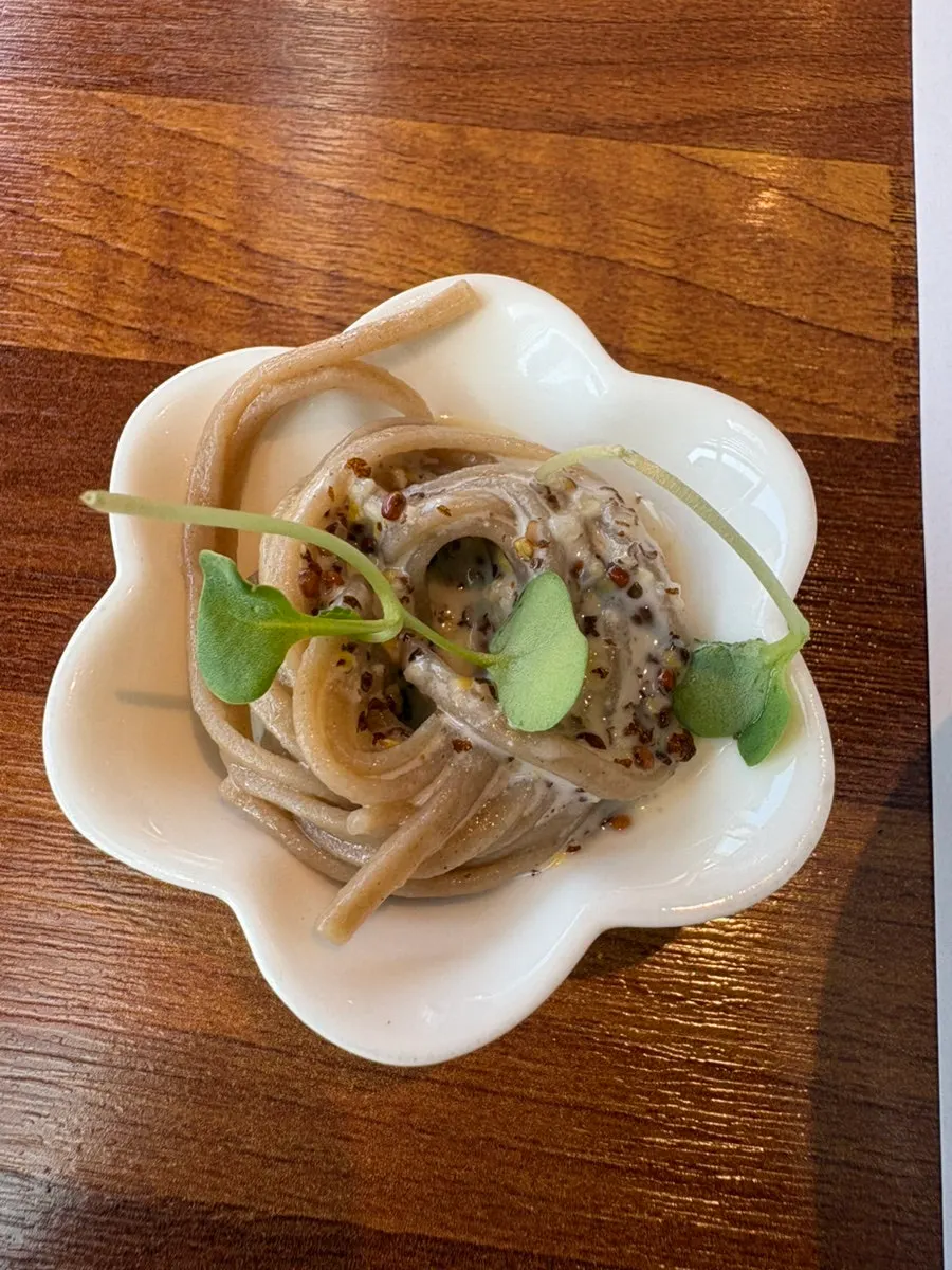 Appetizer of buckwheat noodles in white cream