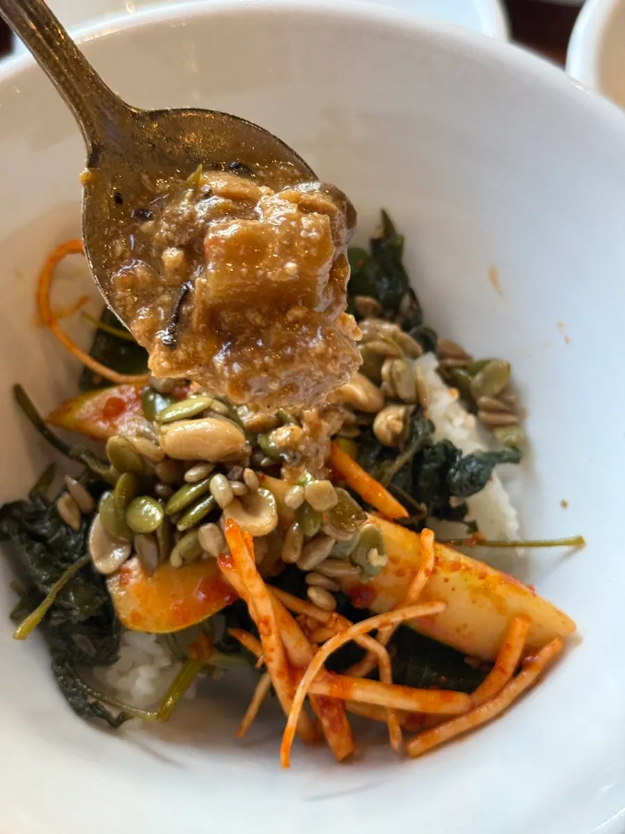 Bibimbap topped with a piece of tteokgalbi