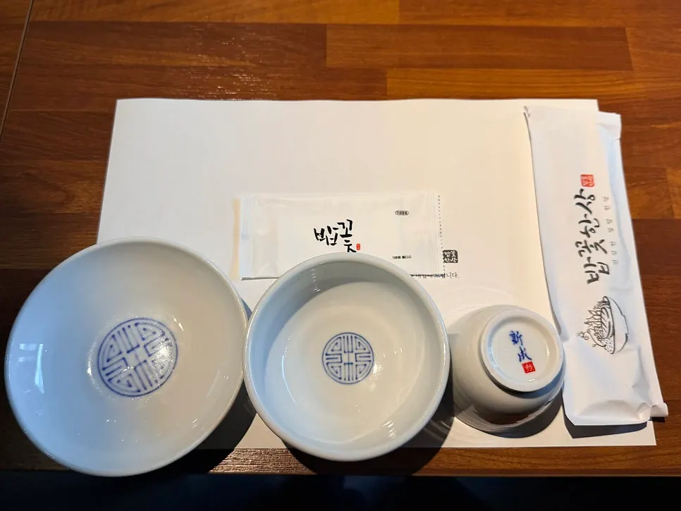 Table with paper-wrapped chopsticks and spoon