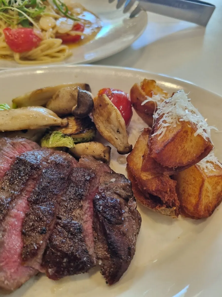 Plated flat iron steak at Olivus Compagno