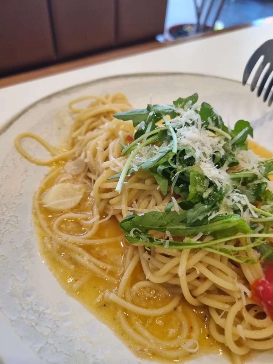 Aglio olio noodles twirled on a fork