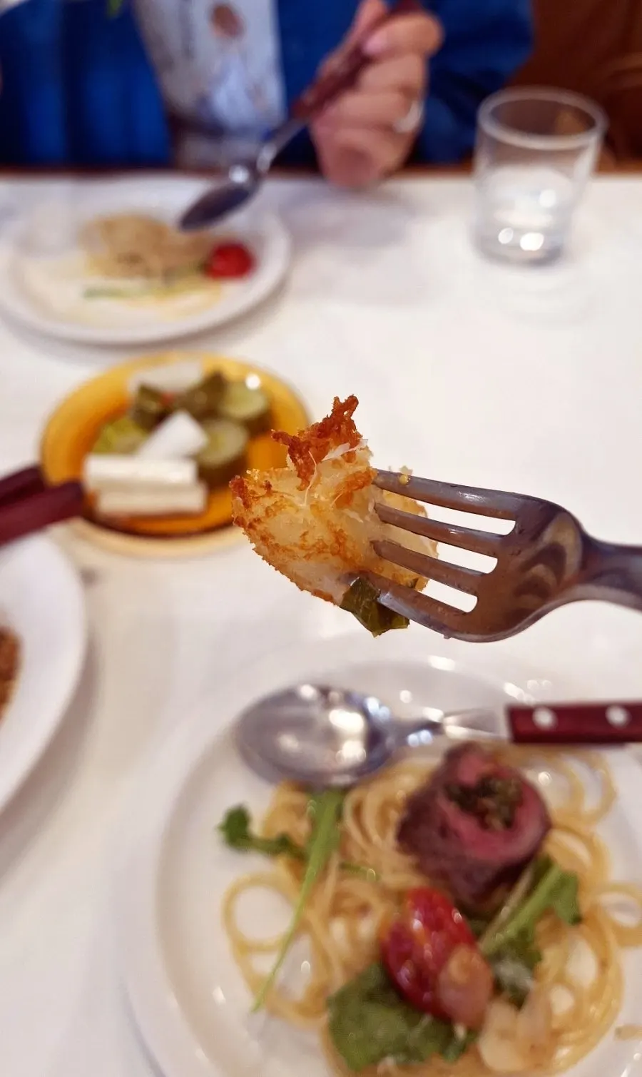 Sauces and potato garnish served alongside the steak