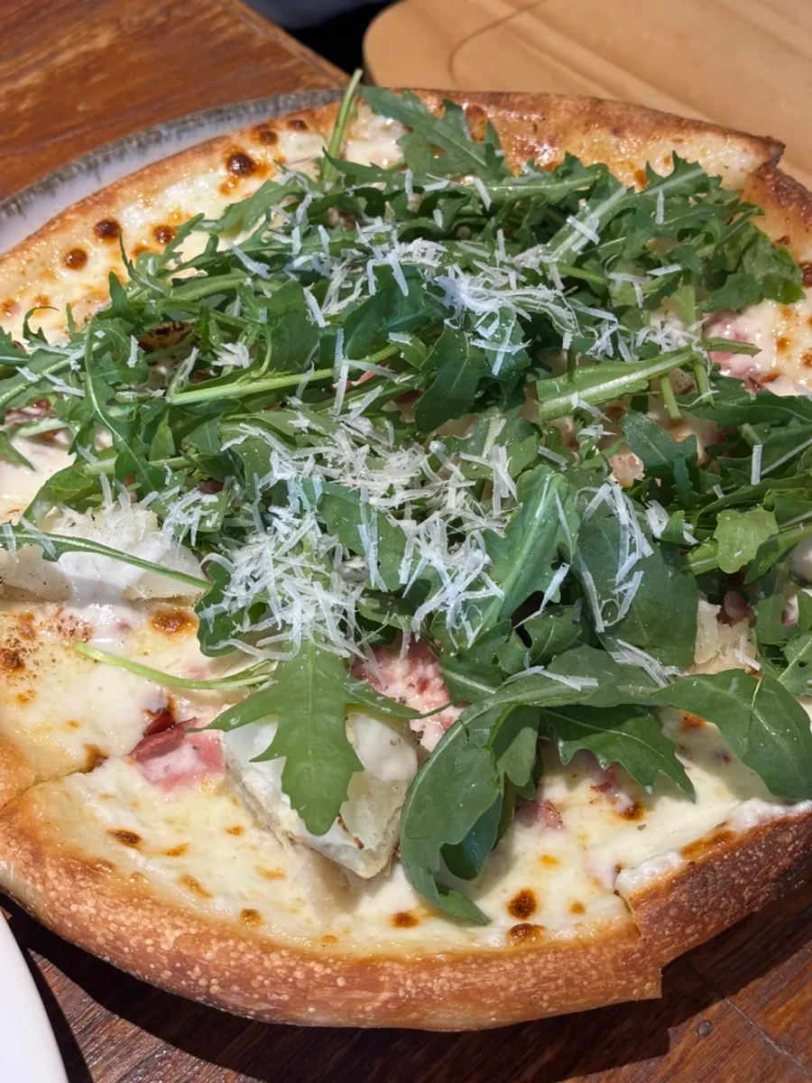 Cream pasta meal served with pizza
