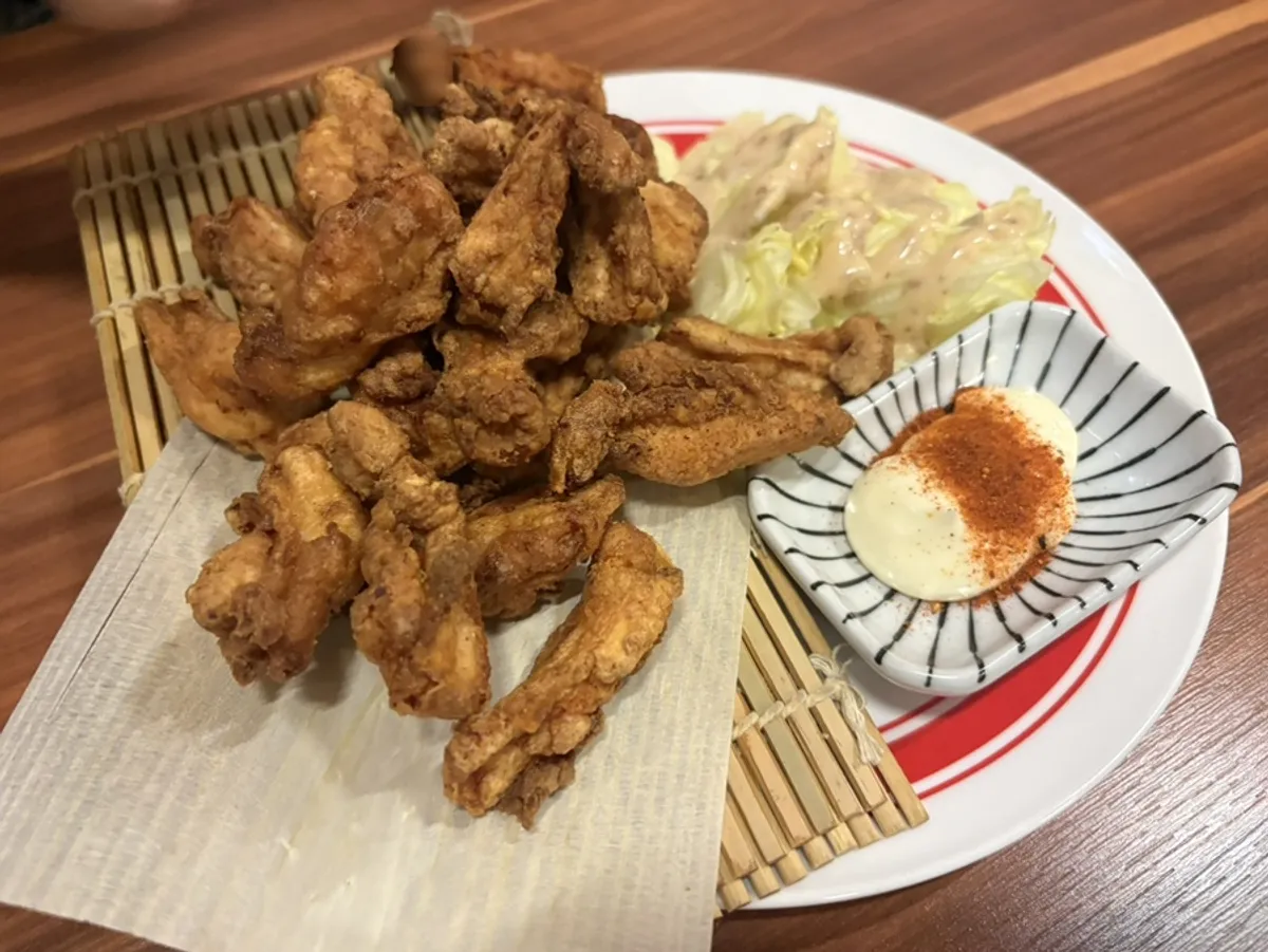 Table setting with the ordered chicken cartilage karaage and grilled Patagonian toothfish at Honma