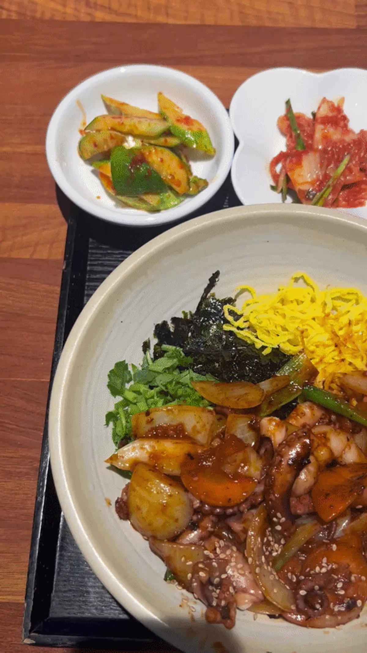 Individual table setting with octopus-shrimp rice bowl