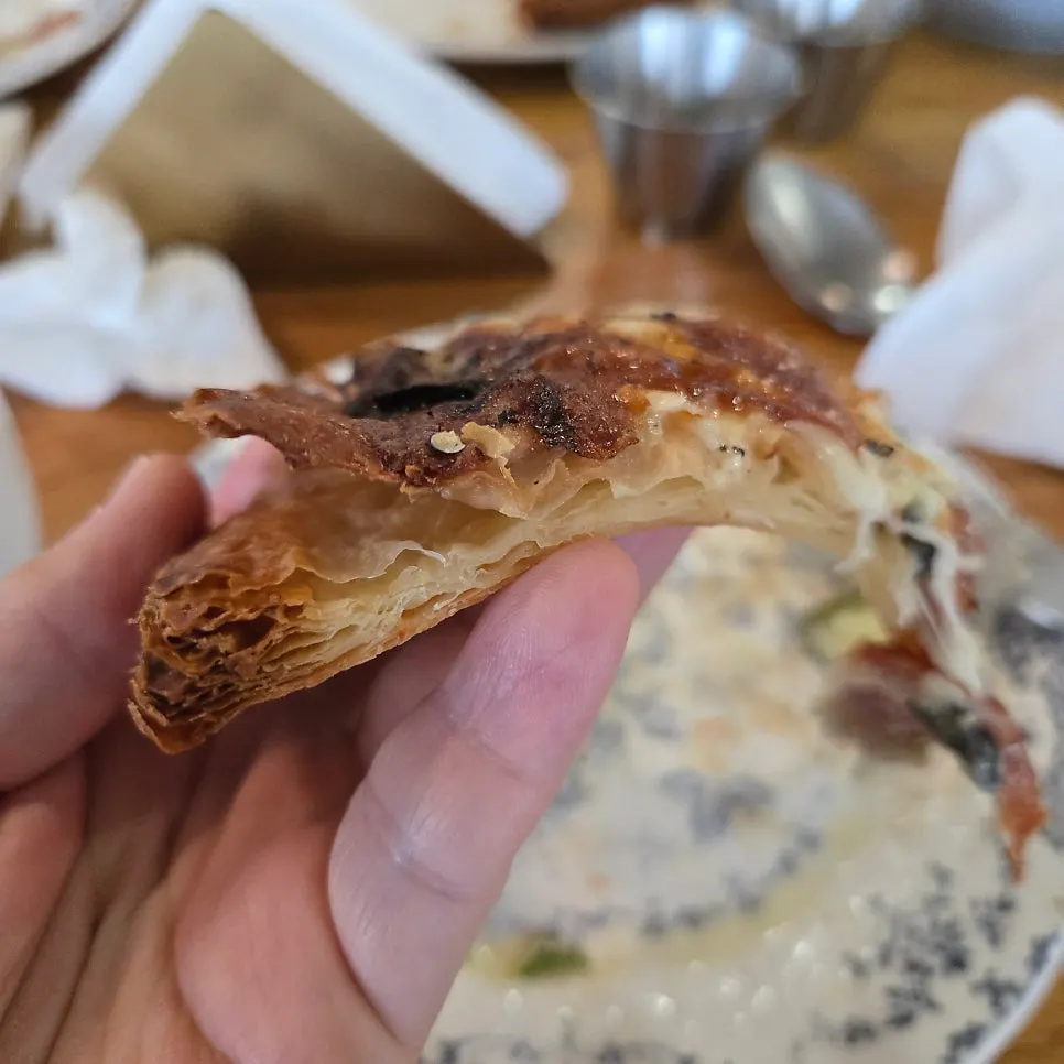 Cross-section of the crisp, layered pizza crust