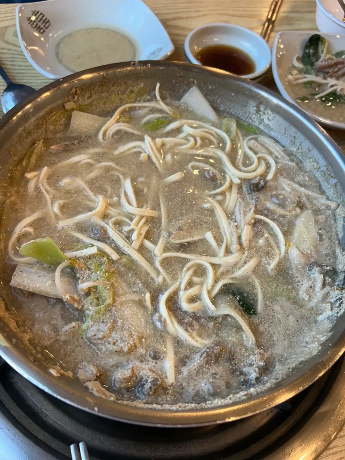 Table setting for two servings of perilla kalguksu shabu-shabu