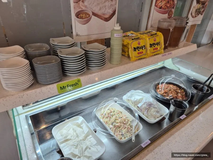 Self-serve bar with side dishes and kalguksu and ramen noodles