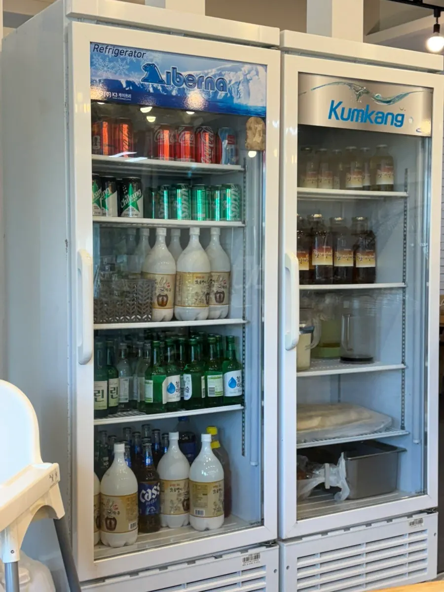 Restaurant fridge stocked with makgeolli