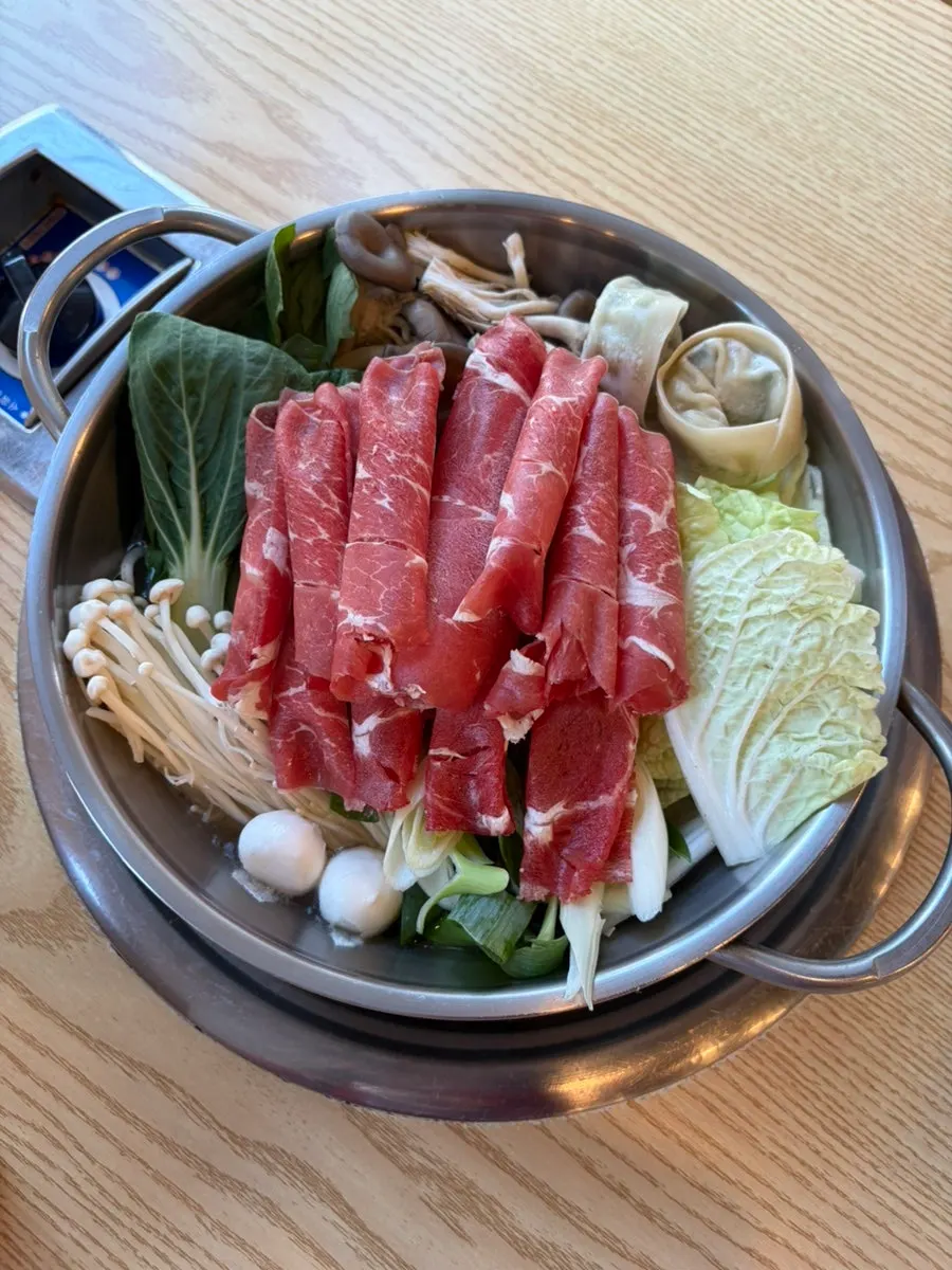Shabu-shabu pot piled high with vegetables and beef