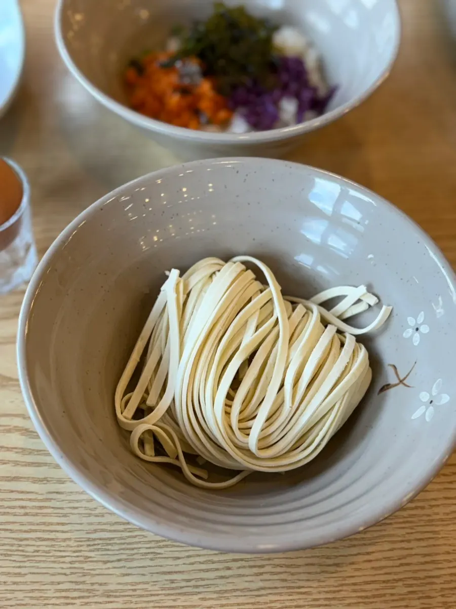 Kalguksu noodle sari and egg vegetable porridge ingredients served together